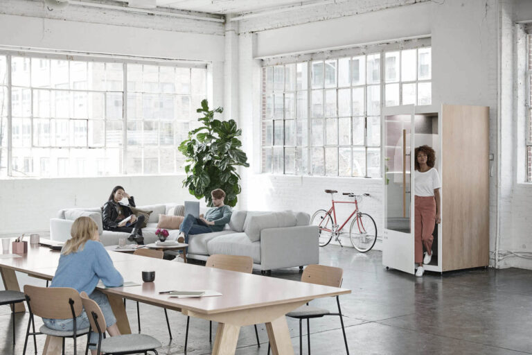 A group of people sitting around a table in an office.