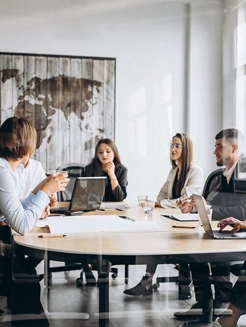 A group of business people sitting around a conference table.