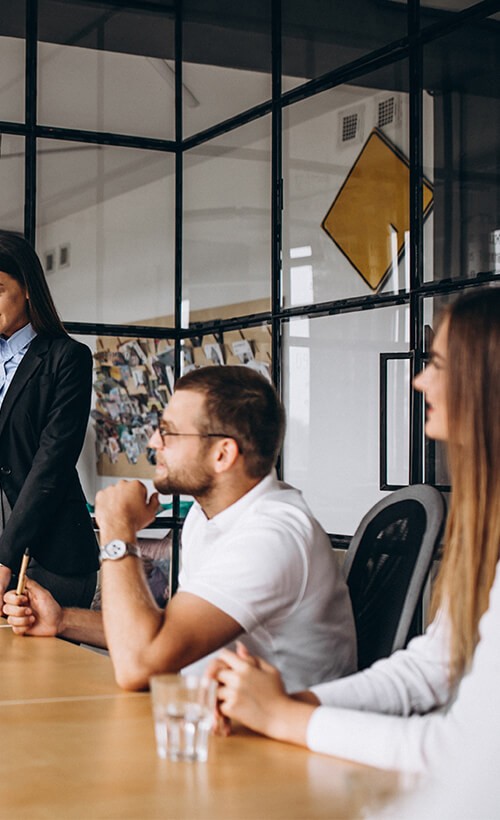 A group of business people sitting around a conference table.