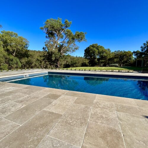 A pool with trees in the background.