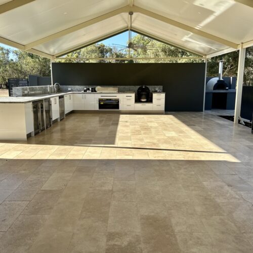 An outdoor kitchen with a tiled floor.