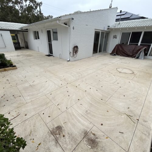 A house with a white patio and plants.